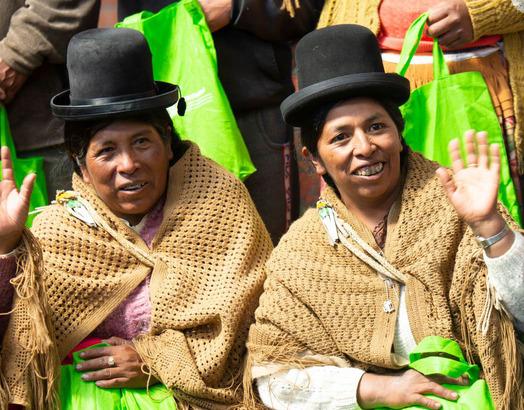 Adela [right] greets  other members of her community group.